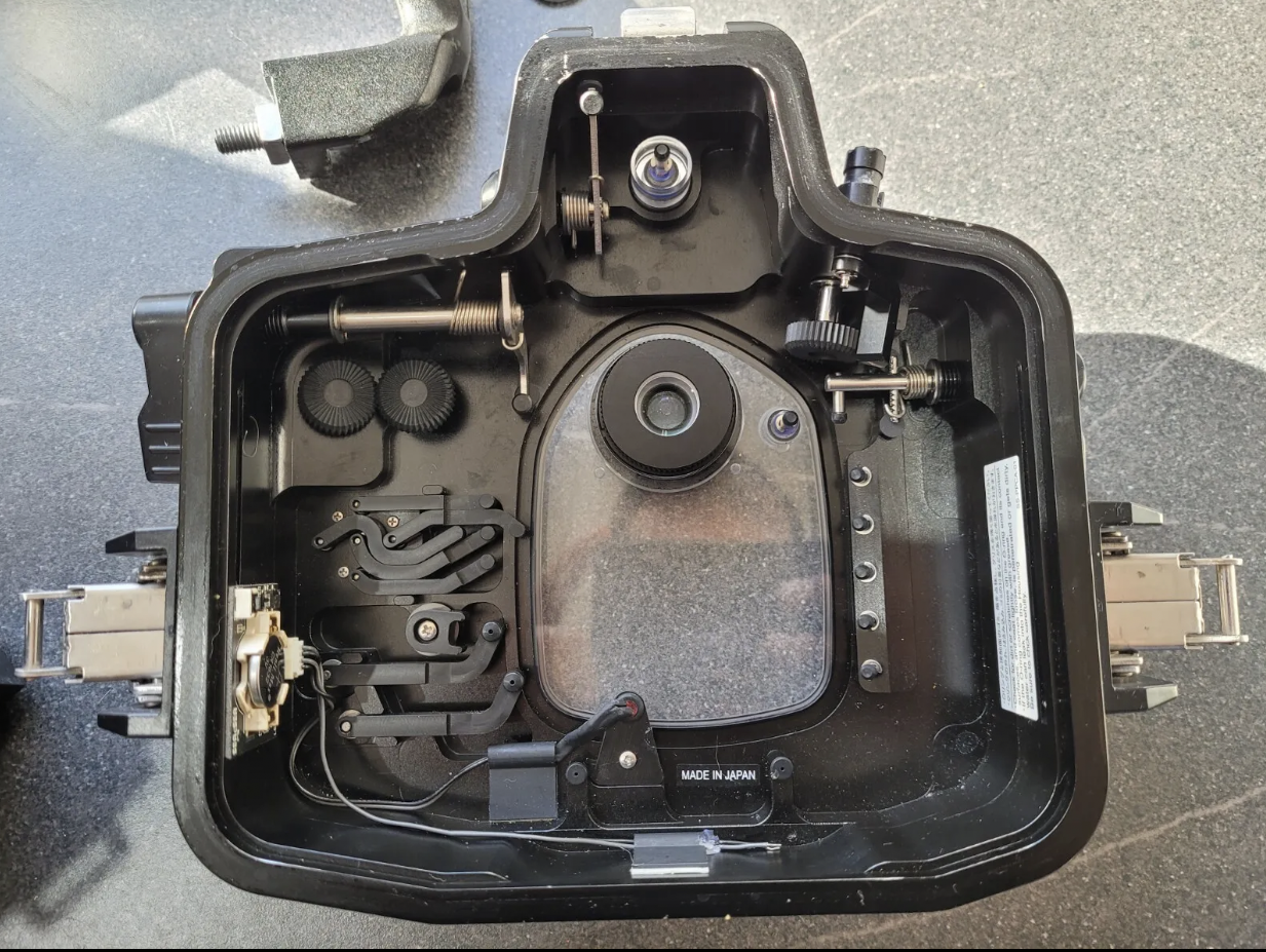 The inside of a camera is shown with the lens removed