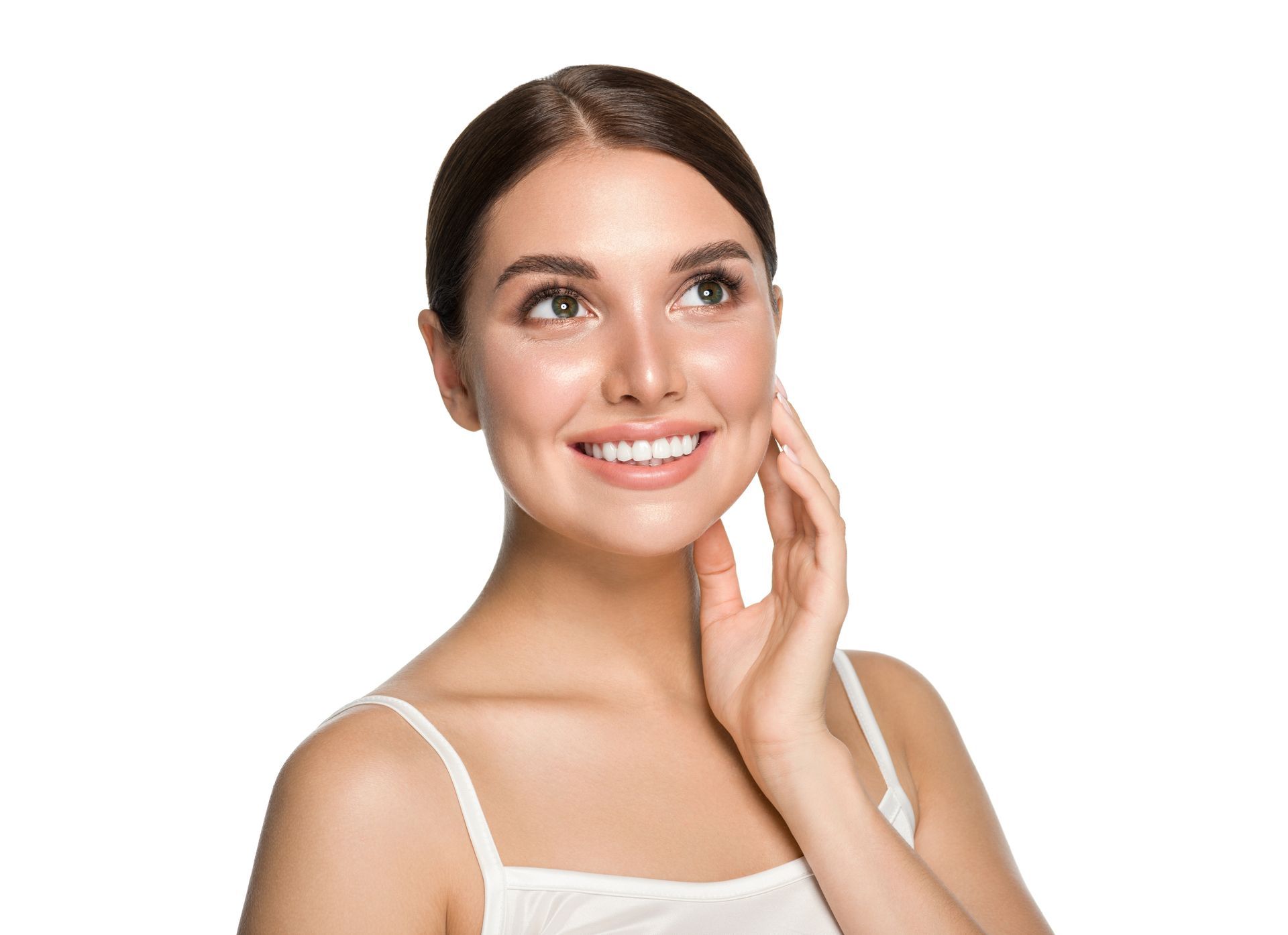 a woman is smiling and touching her face with her hand