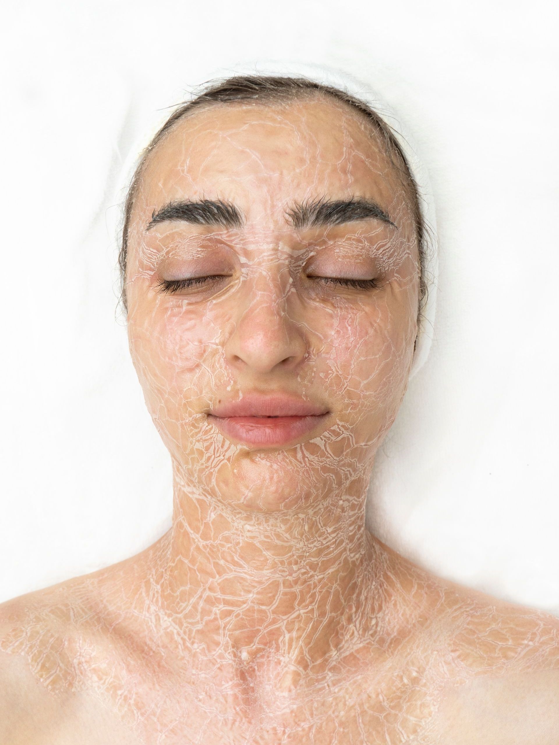 a woman is laying down with a dried mask on her face