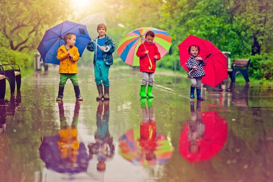 Kids under umbrellas