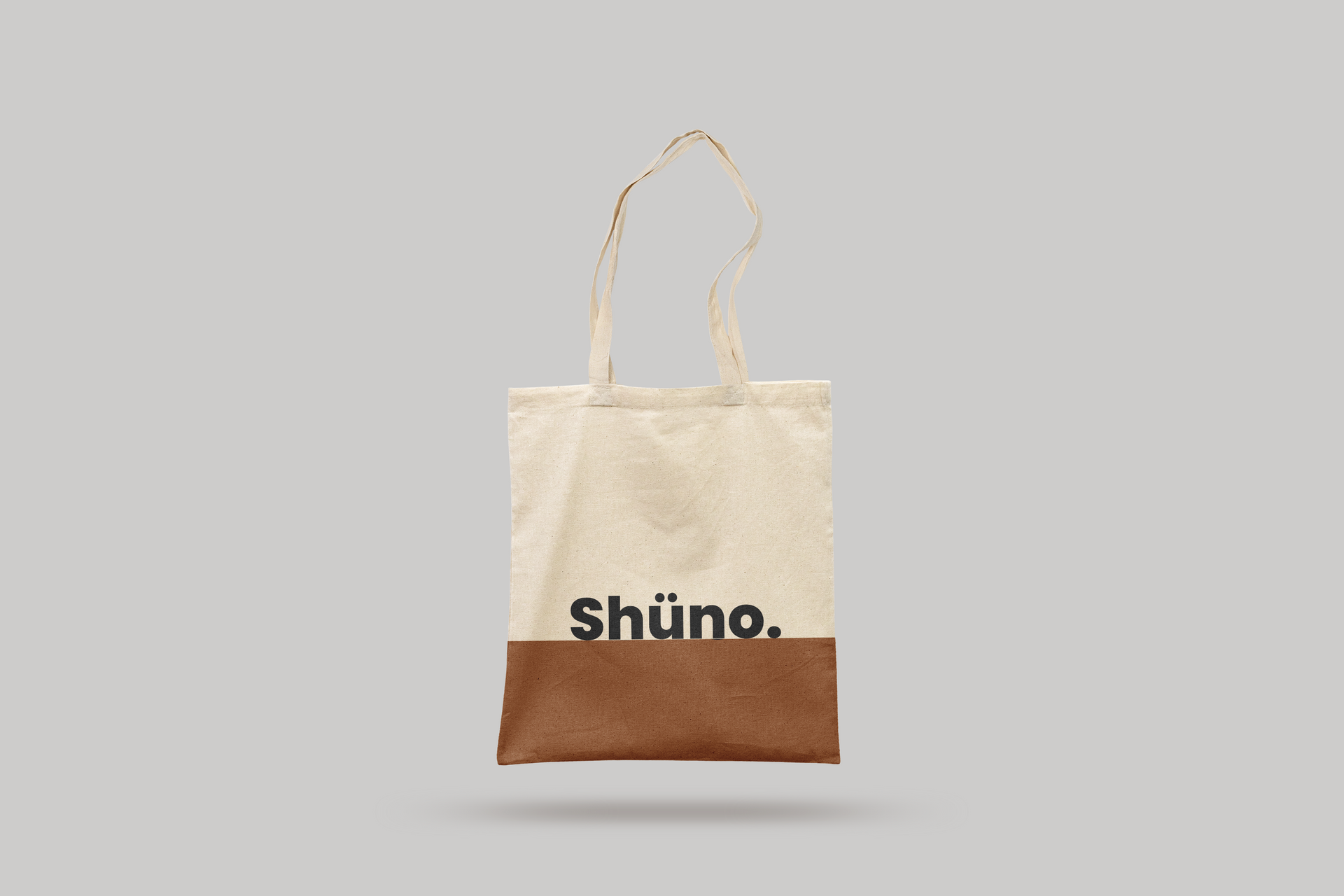 Beige tote bag with brown bottom and