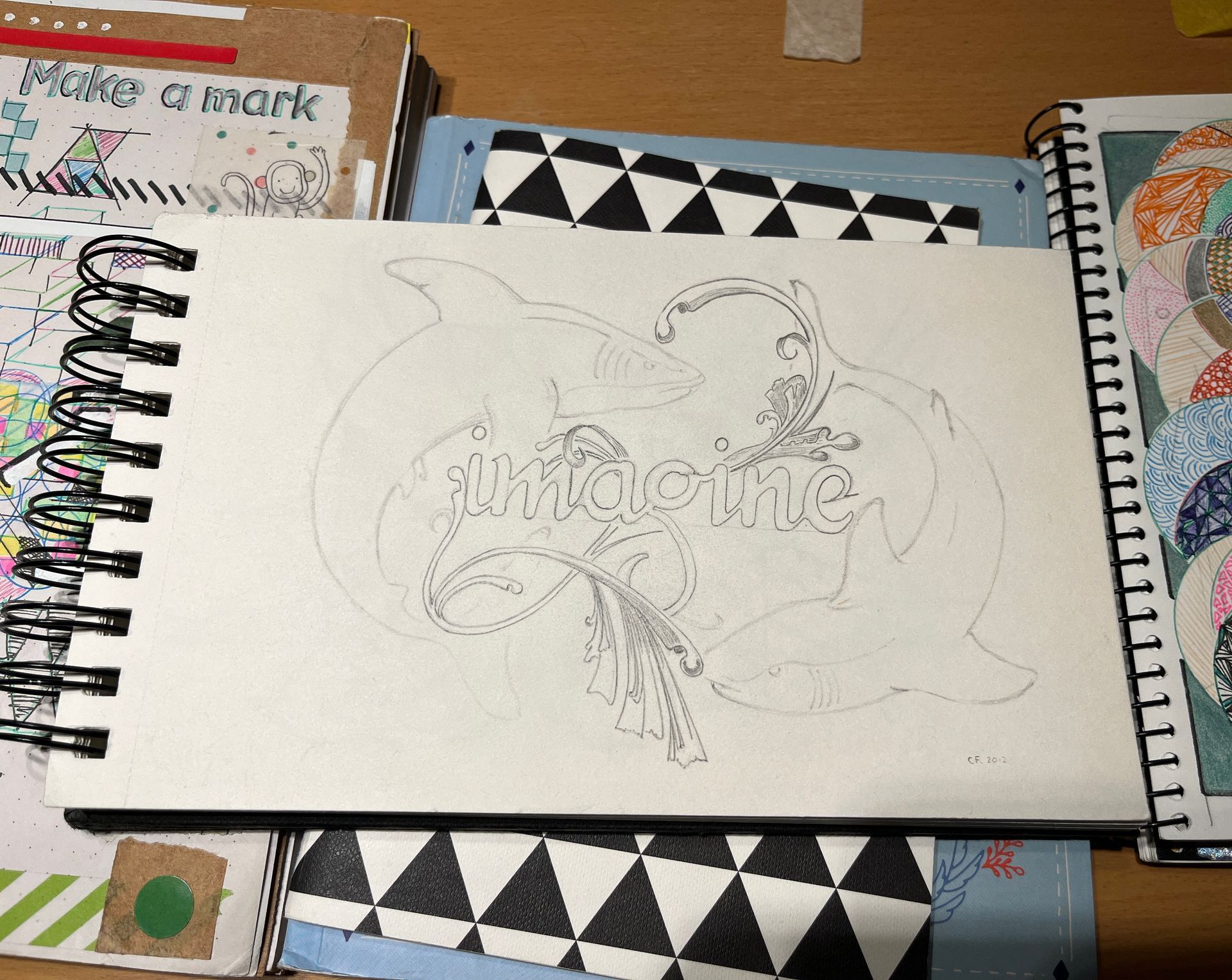 Sketchbook with dolphin outline and