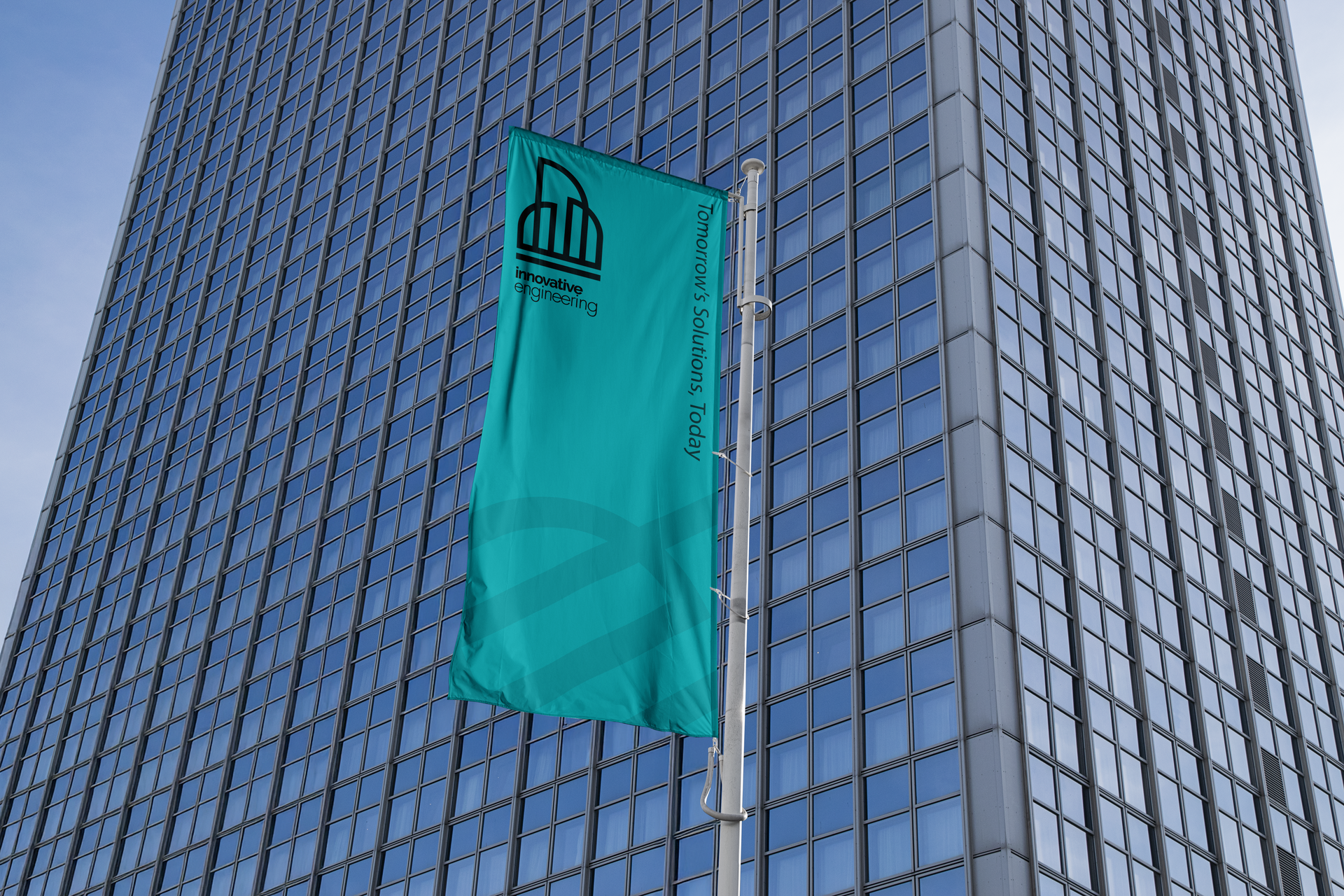 Tall skyscraper with a green flag displaying a logo.