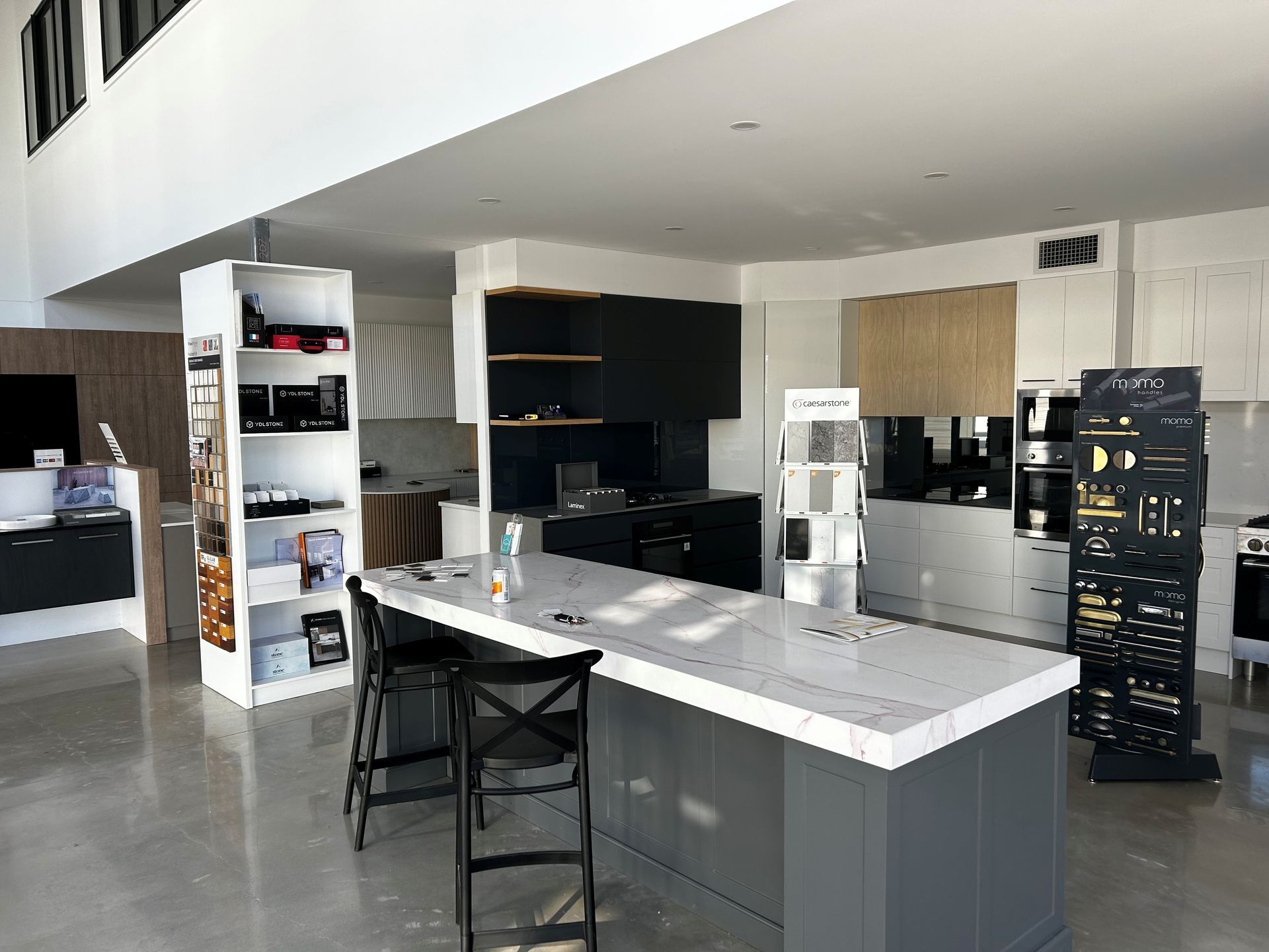 A Showroom Featuring a Kitchen Island With White Countertops — Foreshore Kitchens in Mooloolaba, QLD