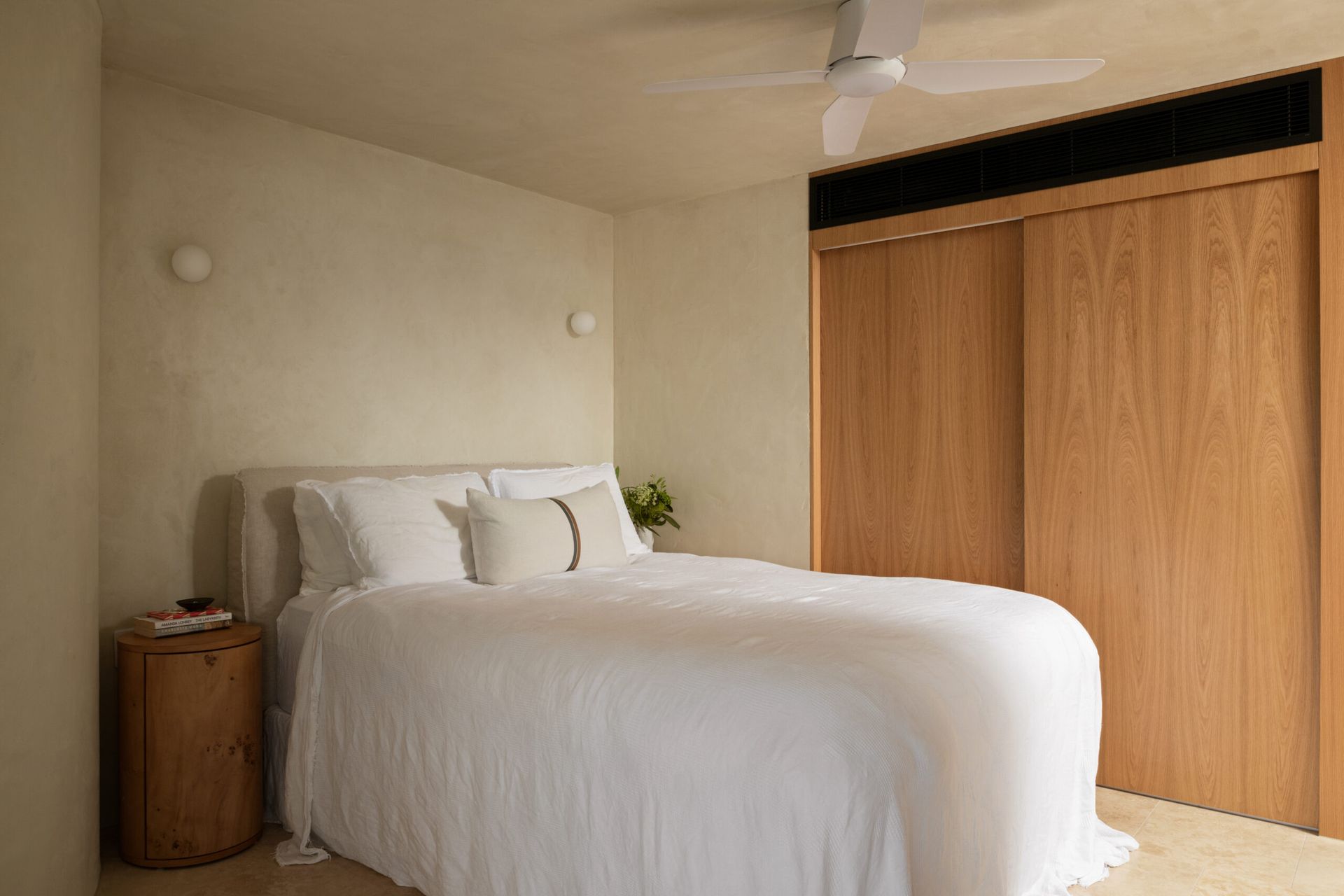 Neutral-toned Bedroom With a Bed Featuring White Bedding — Foreshore Kitchens in Coolum Beach, QLD