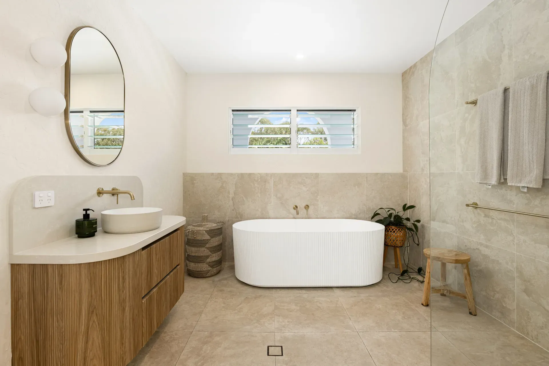A Modern Bathroom Featuring a Light Wood Vanity, Round Vessel Sink — Foreshore Kitchens in Caloundra, QLD
