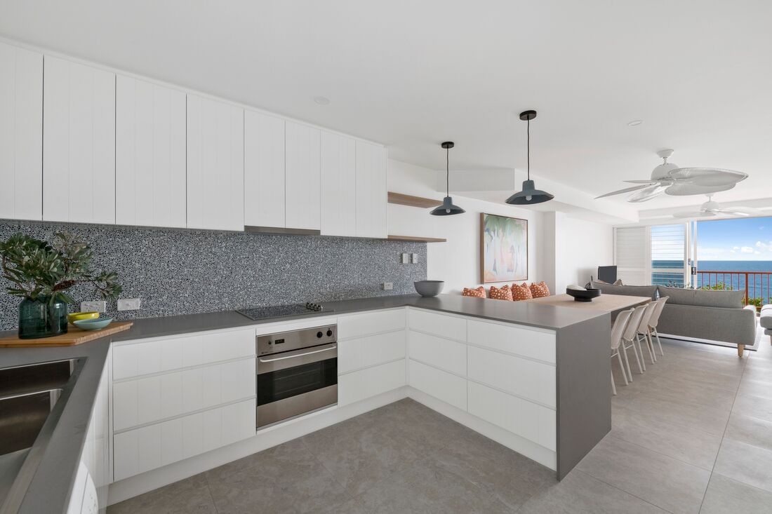 Open-plan Dining and Kitchen Area With White Cabinets — Foreshore Kitchens in Coolum Beach, QLD