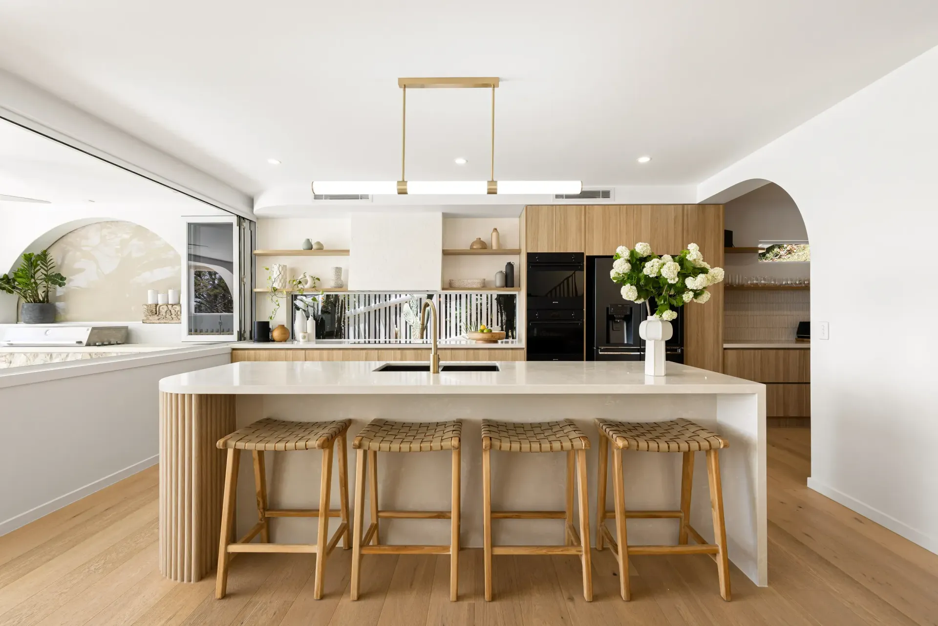 Bright Kitchen Featuring a White Island With Four Wooden Stools — Foreshore Kitchens in Noosa, QLD