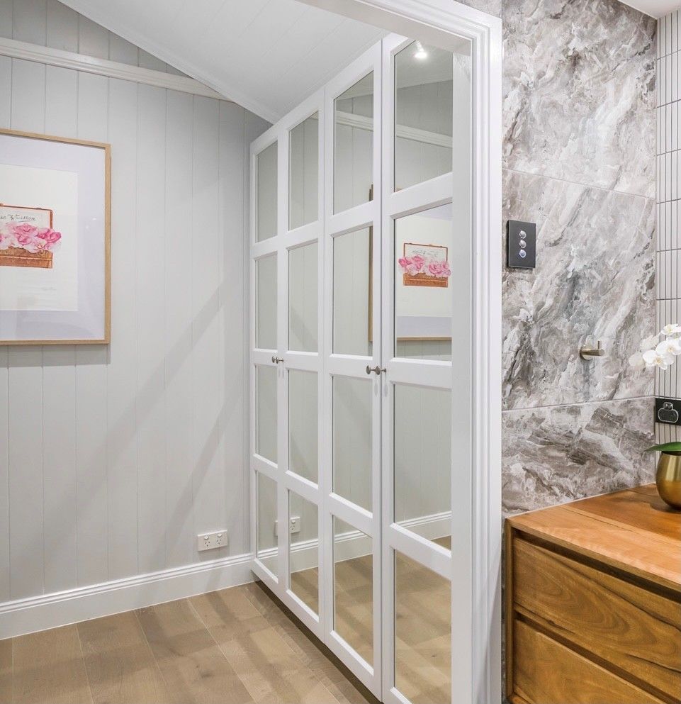 A White Glass-paneled Closet Door Next to a Grey Marble Wall — Foreshore Kitchens in Coolum, QLD
