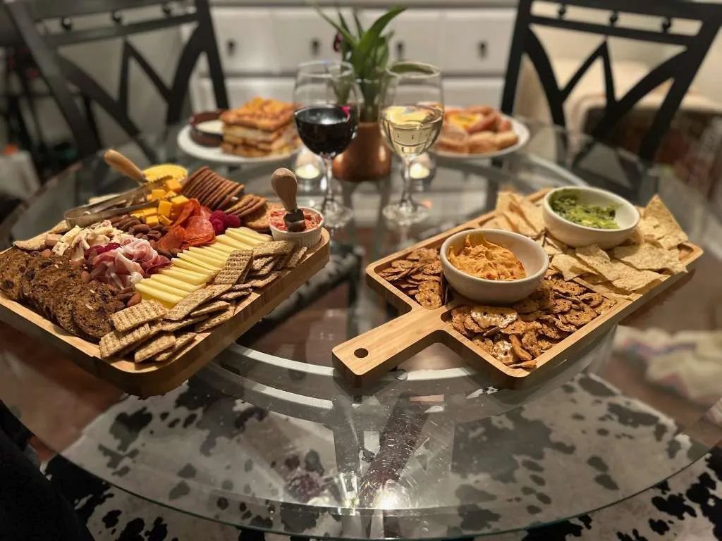 A table topped with plates of food and wine glasses.