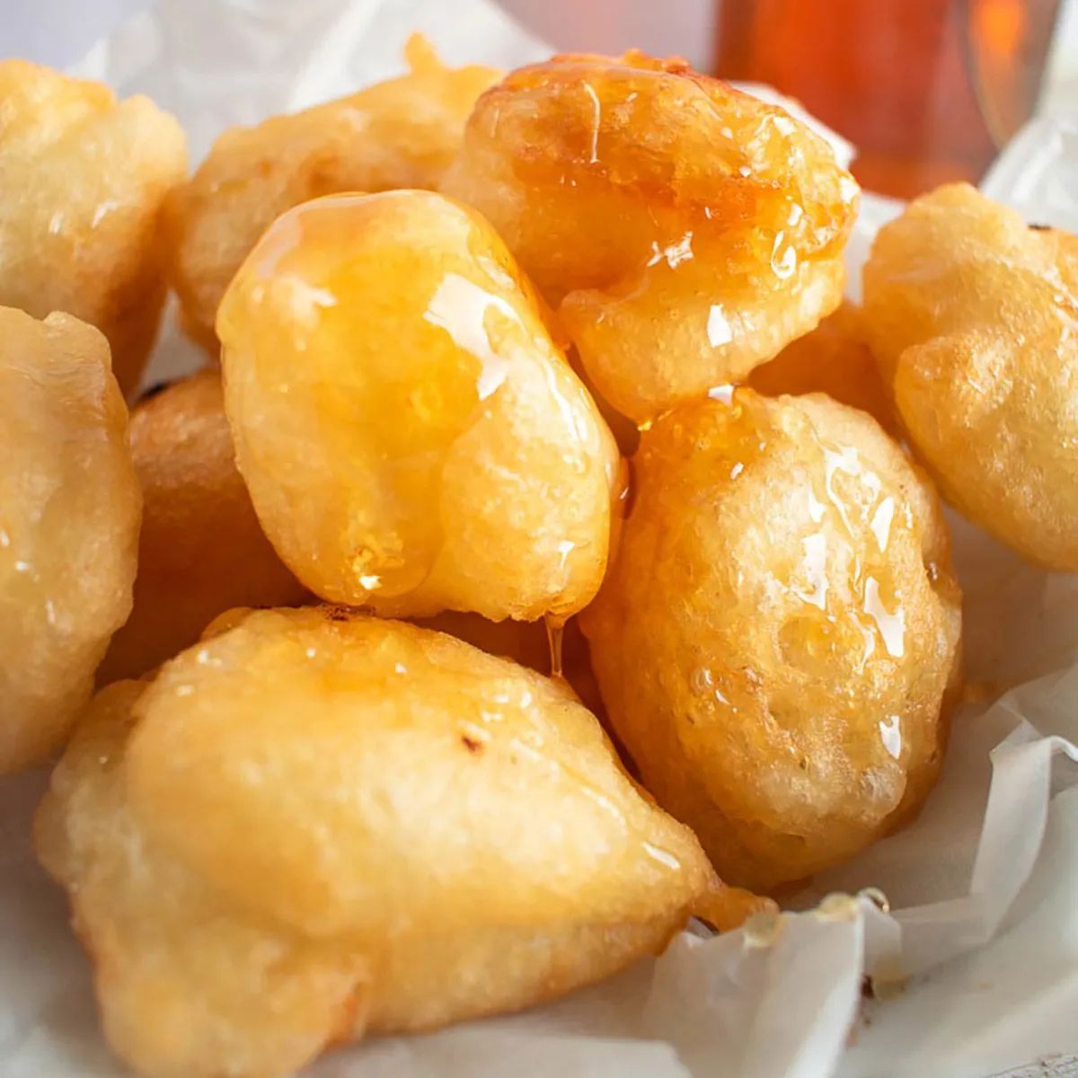 A close up of fried food on a plate on a table.