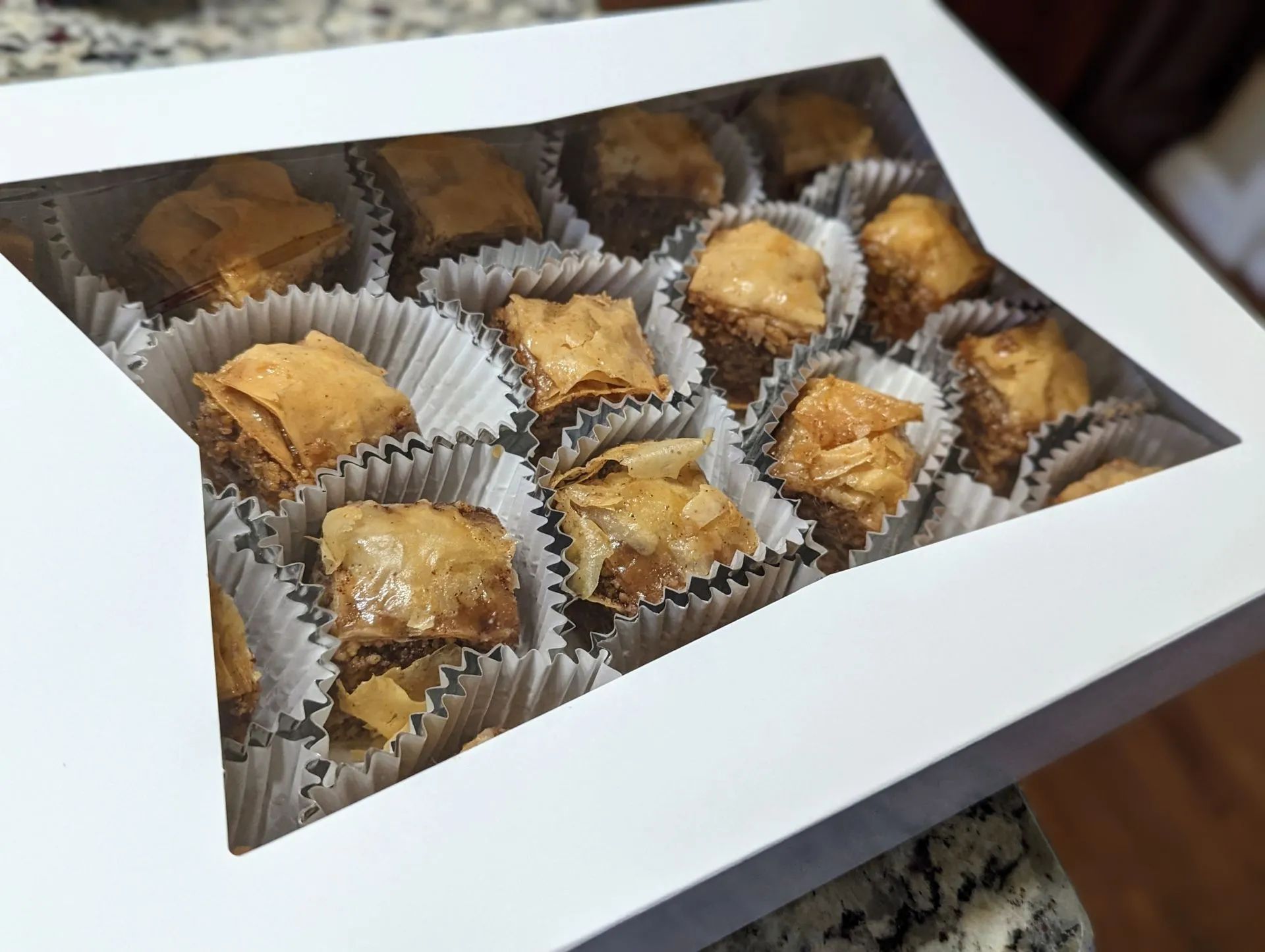 A box of baklava is sitting on a counter.