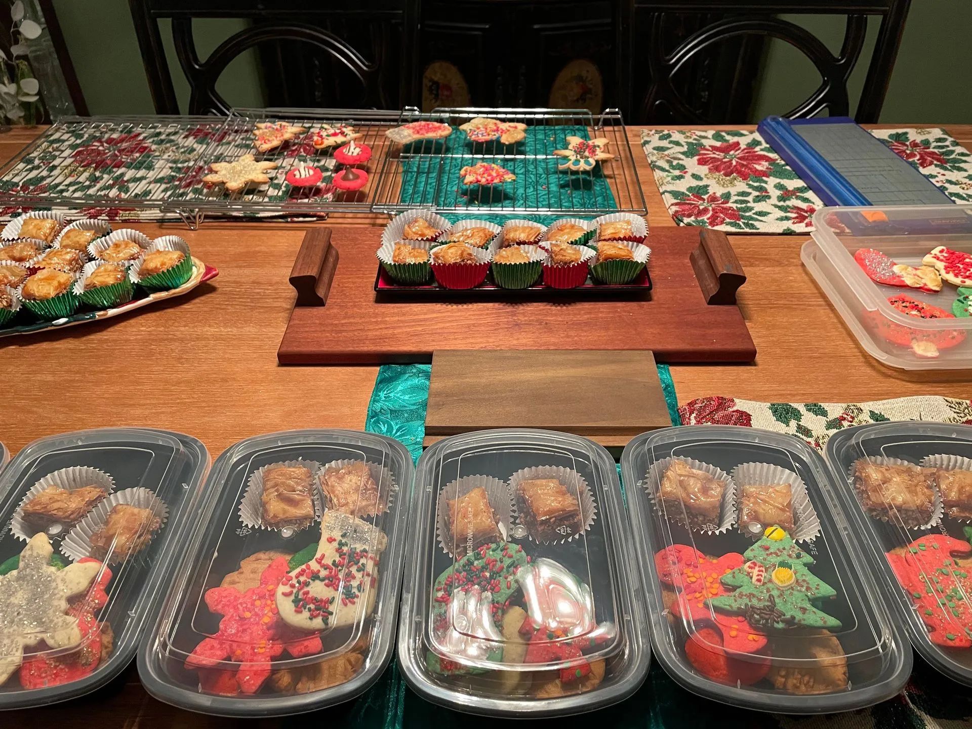A table topped with a variety of cupcakes and cookies.