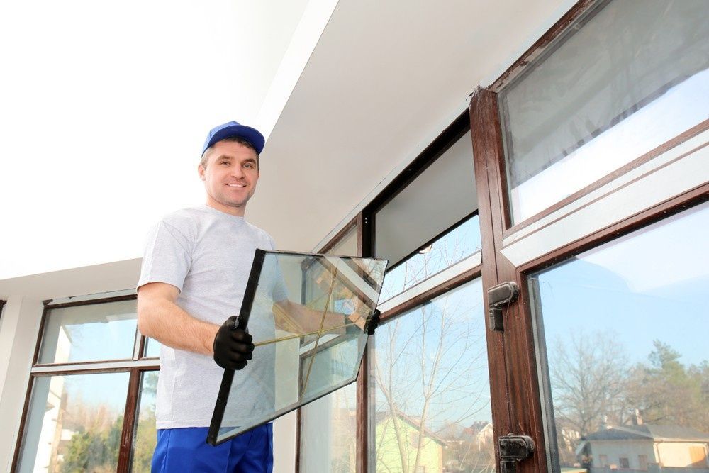 A Man in Uniform Replacing a Window Pane — Envy Glass in Nambucca Heads, NSW