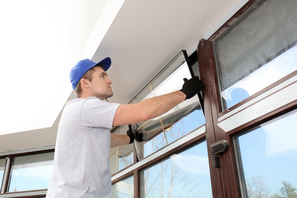 A Man Installing a Window Frame — Envy Glass in Nambucca Heads, NSW