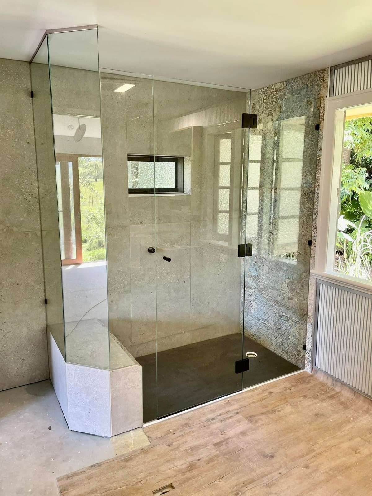 A Large Shower Screen with styled tiles surrounding the inside area of the shower — Envy Glass in Nambucca Heads, NSW
