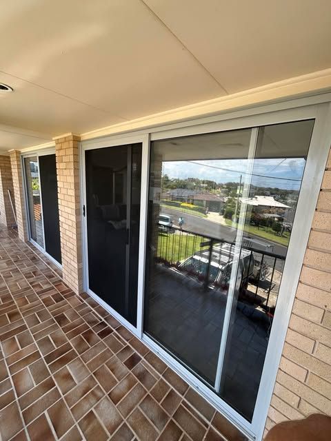 Sliding Glass Doors with Screen Doors on A Brick Patio — Envy Glass in Nambucca Heads, NSW.