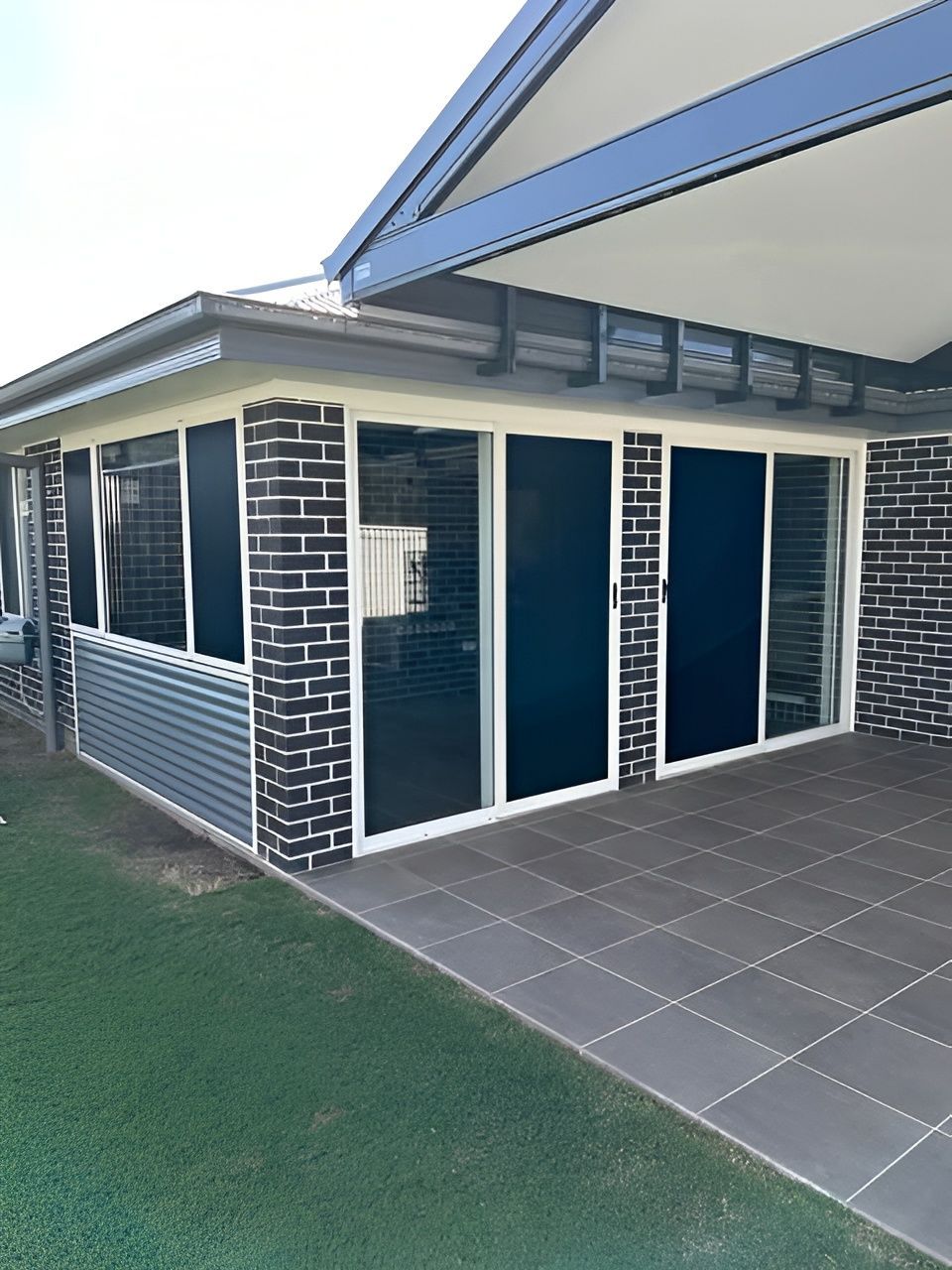 Outdoor Patio with Dark Brick and Sliding Glass Doors — Envy Glass in Nambucca Heads, NSW