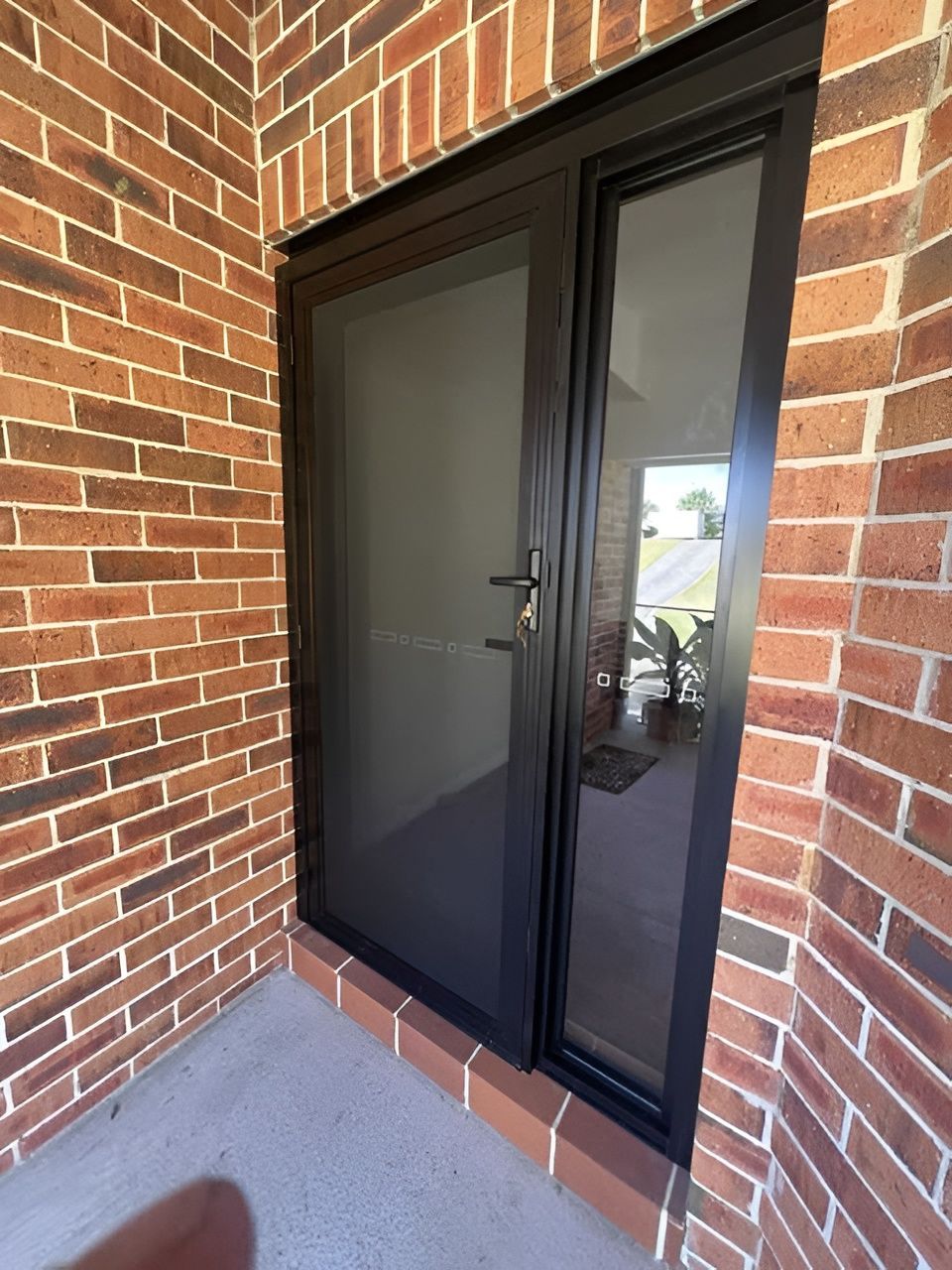 Black Screen Door with Side Window in A Brick Entryway — Envy Glass in Nambucca Heads, NSW
