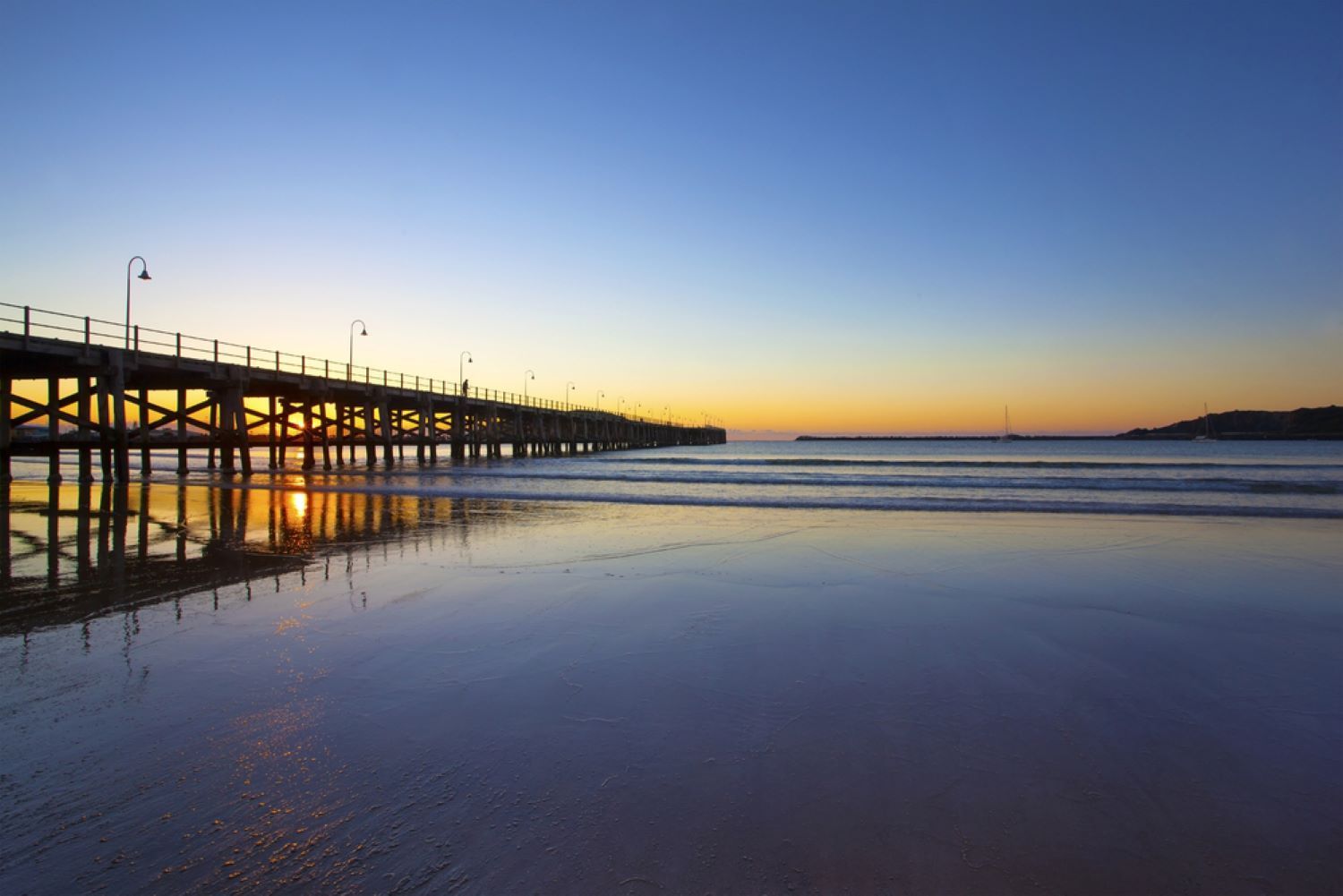 A Pier Over Calm Water Reflecting a Sunset — Envy Glass in Coffs Harbour, NSW