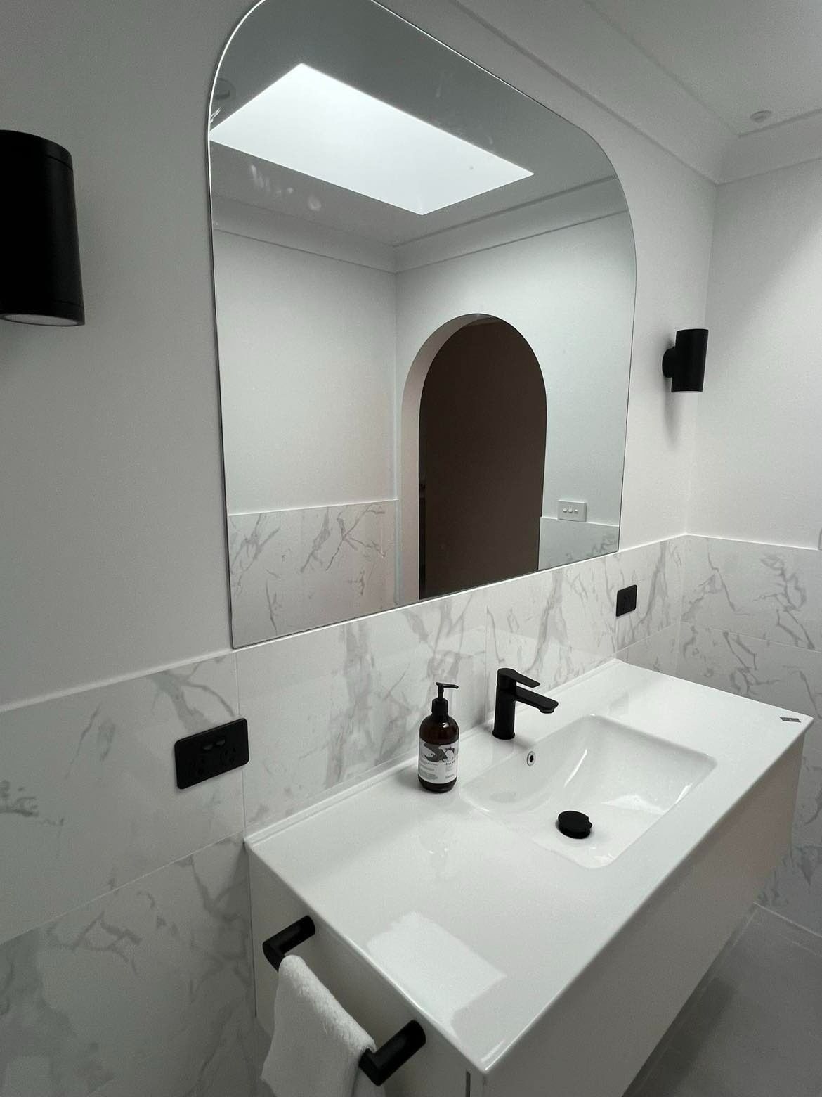 A Bathroom with A Large Arched Mirror — Envy Glass in Nambucca Heads, NSW