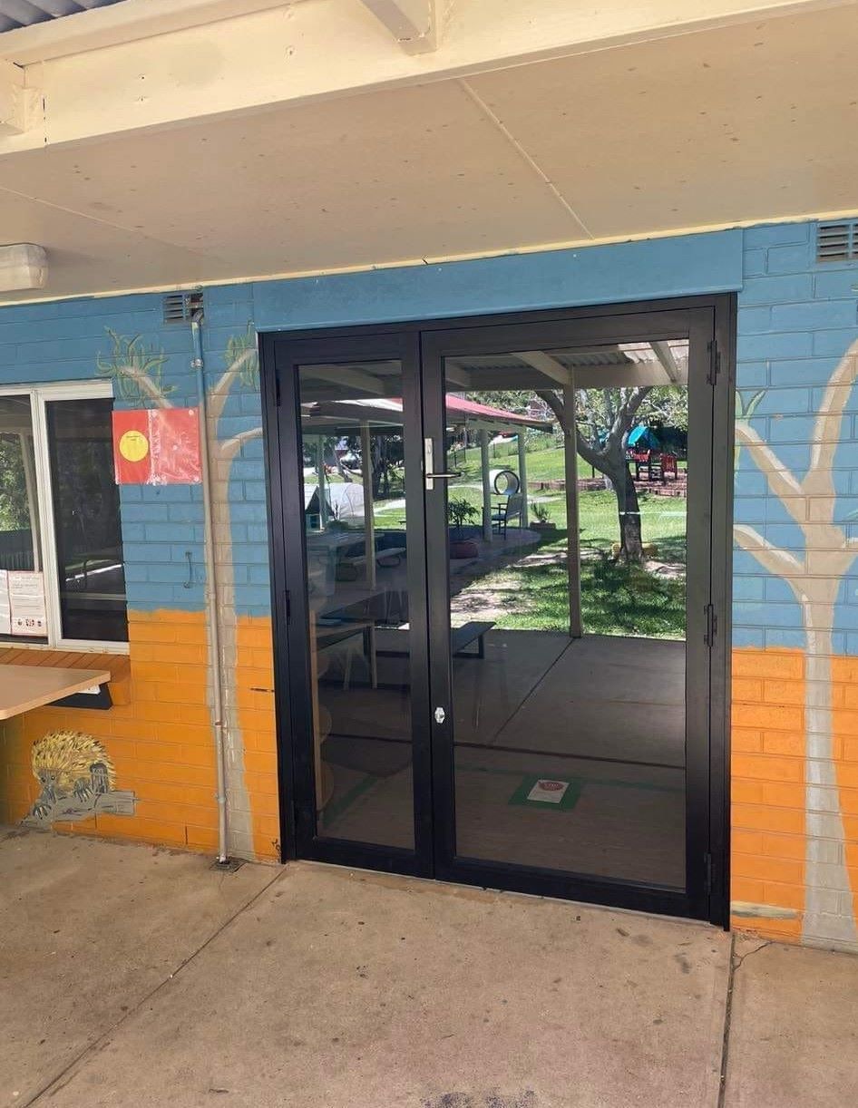 A Framed Double Glass Doors Set in A Brick Wall — Envy Glass in Bellingen, NSW