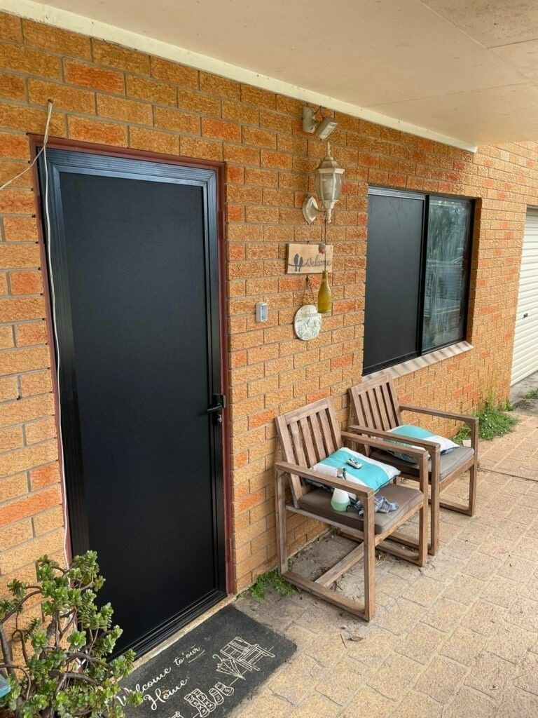 A Brick Exterior with Black Door — Envy Glass in Nambucca Heads, NSW
