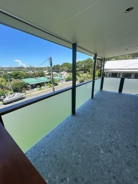 A Balcony View of A Neighborhood with Frosted Glass Panels — Envy Glass in Coffs Harbour, NSW