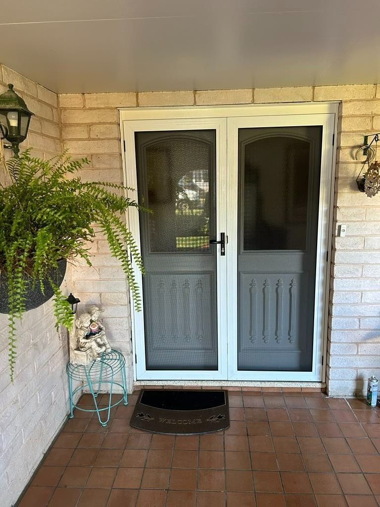 A Double White Screen Doors on A Brick Porch — Envy Glass in Nambucca Heads, NSW