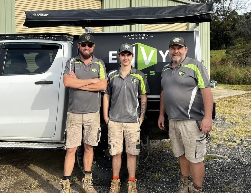 A team of three men in Envy Glass uniform are standing in front of company ute — Envy Glass in Nambucca Heads, NSW