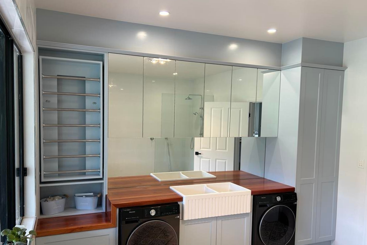 Laundry Room with Light Blue Cabinets, Wooden Countertops, and Black Appliances — Envy Glass in Nambucca Heads, NSW