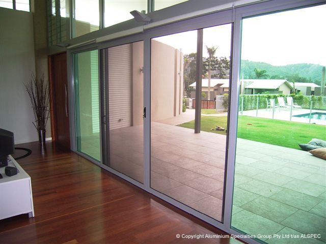 A Sliding Glass Door with A Bed — Envy Glass in Nambucca Heads, NSW