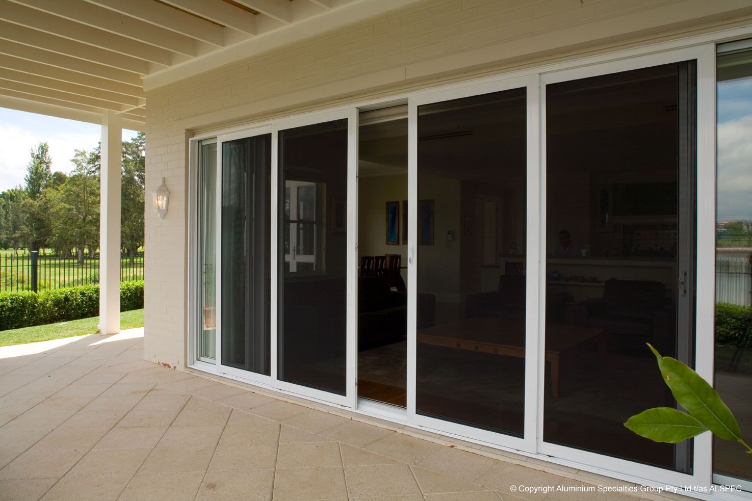 Sliding Glass Doors With White Frames And Dark Screens — Envy Glass in Nambucca Heads, NSW
