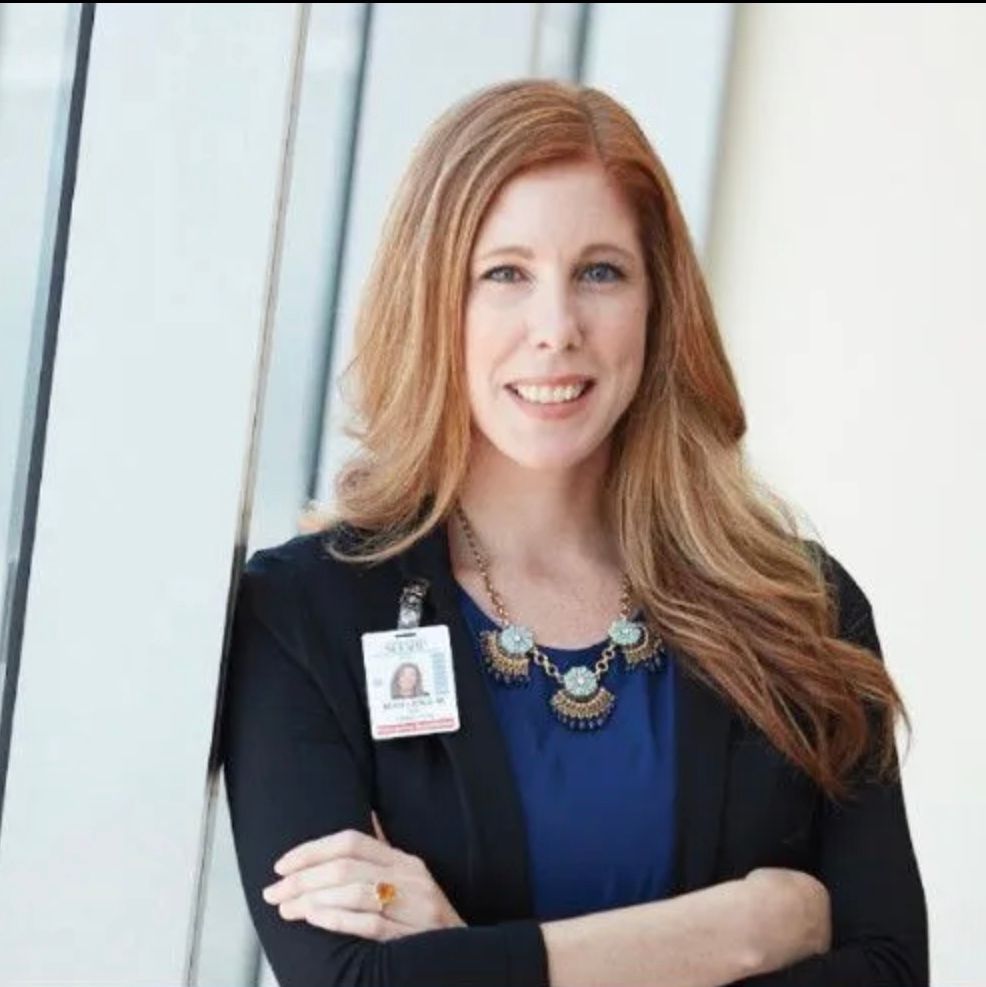 A woman wearing a name tag that says ' a ' on it