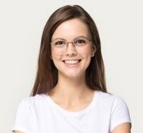 Woman with brown hair and glasses smiles, wearing a white t-shirt.