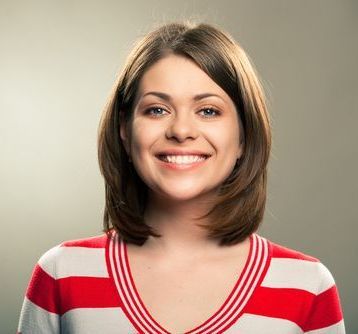 Woman with bobbed brown hair, wearing a red and white striped shirt, smiling.