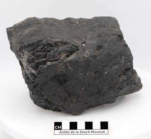 Wooden gong with mallet, and brass bell suspended from a frame.