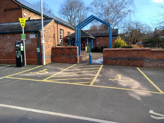 A handicapped parking spot in front of a building