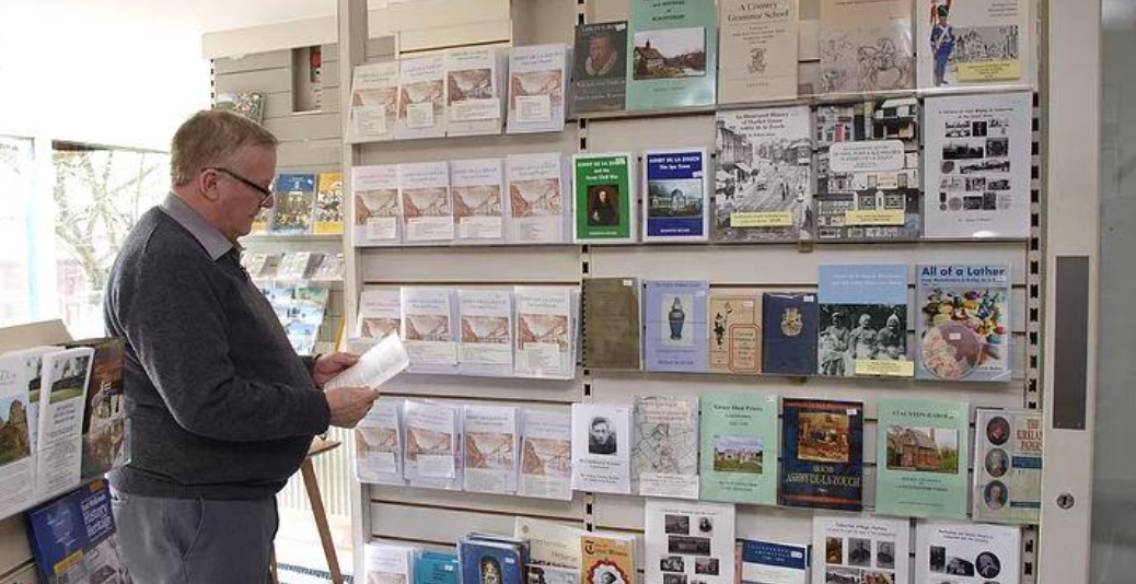 A man is looking at books in a bookstore.