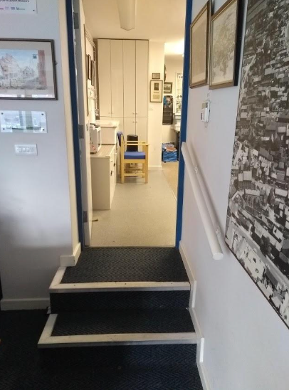 A hallway with stairs leading up to a room