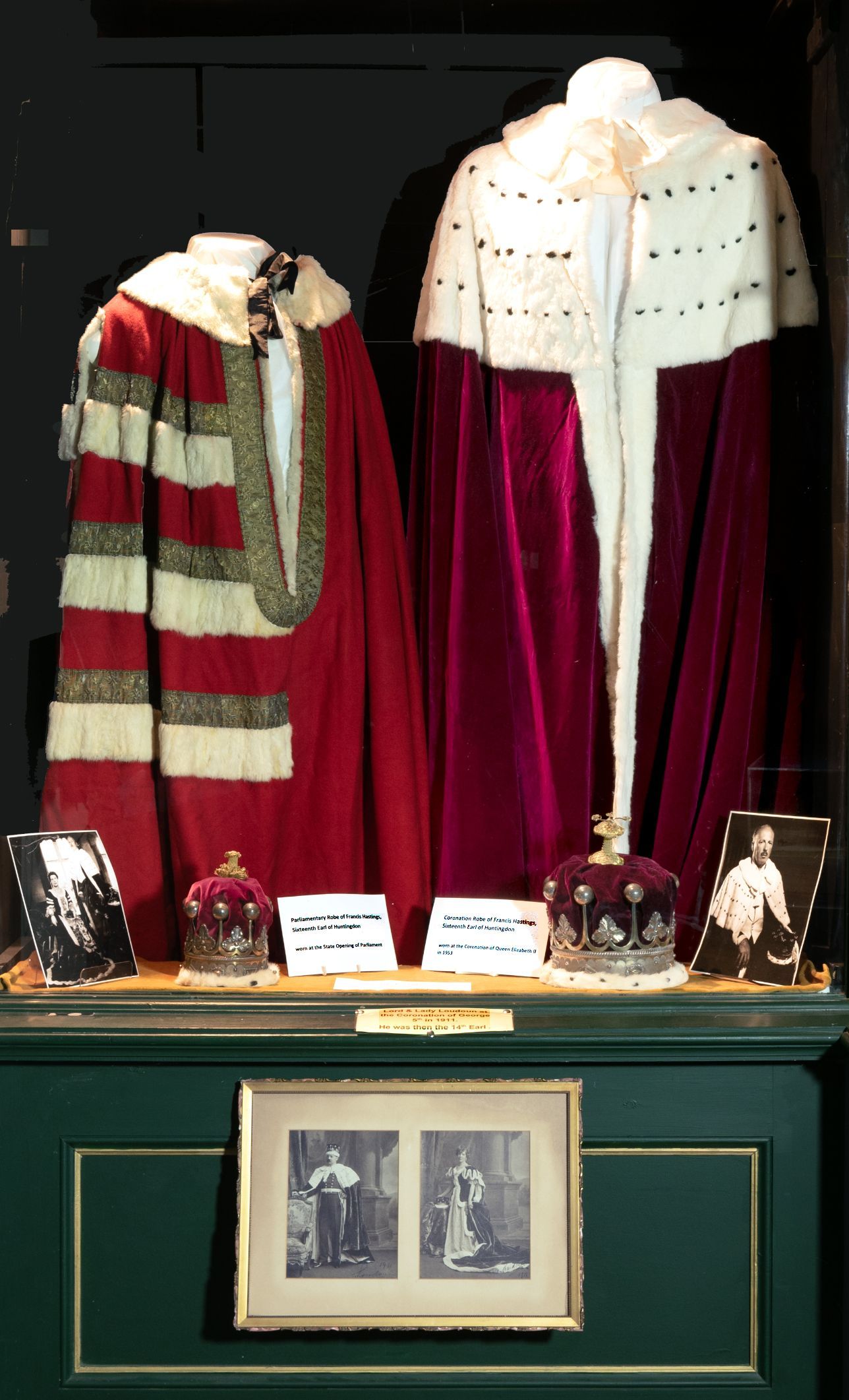 A window display with a red coat and a white coat