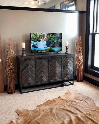 A television is sitting on a wooden entertainment center in a living room.