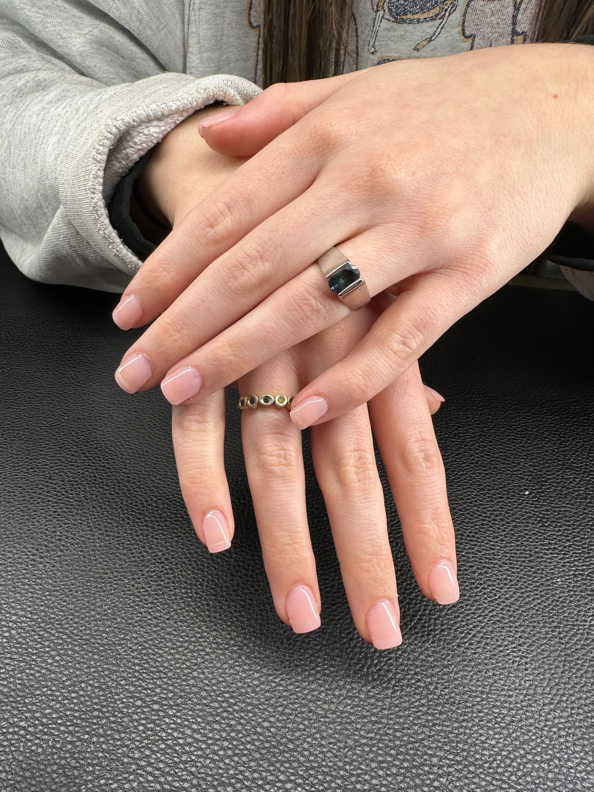 A woman is wearing a ring on her left hand