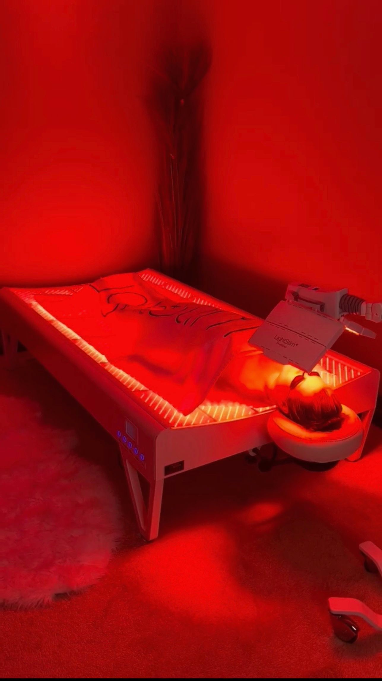 A bed with red lights on it in a dark room.