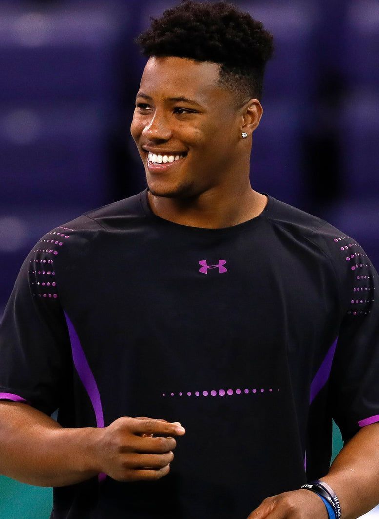 A man wearing a black under armour shirt is smiling