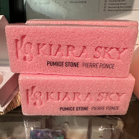 Two pink pumice stones are stacked on top of each other