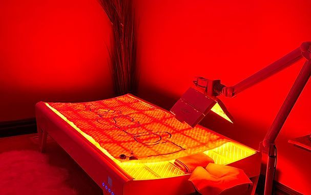 A bed with a red light on it in a room.