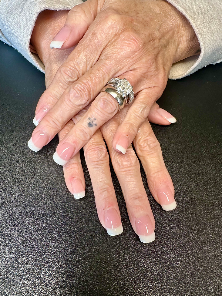 A close up of a woman 's hands with a ring on her finger.