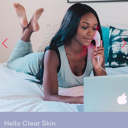 A woman is laying on a bed using a laptop computer.