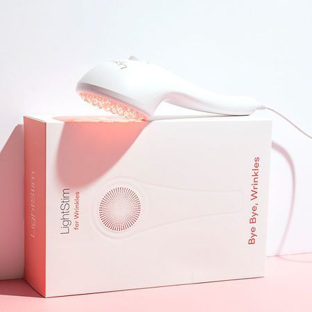 A light slim device is sitting on top of a pink box.